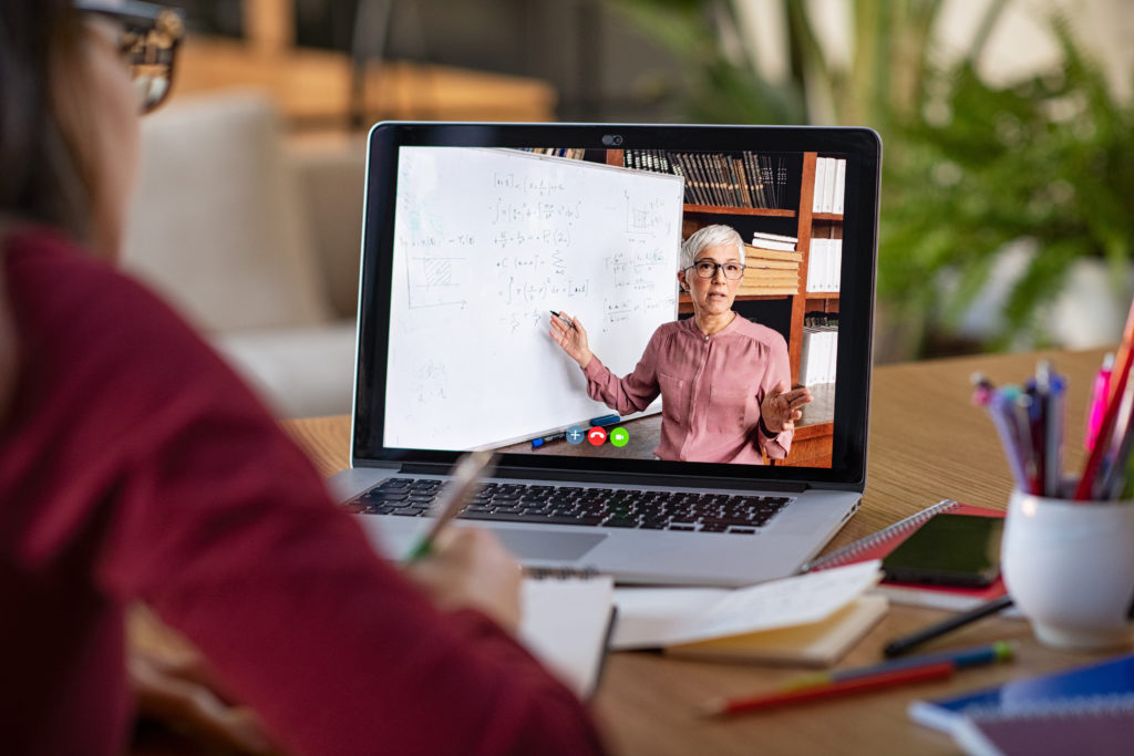 Student watching a teacher in an online course