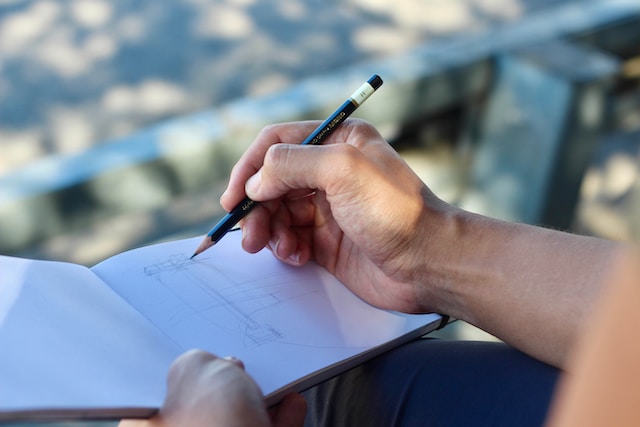 A person sketching in a sketchbook